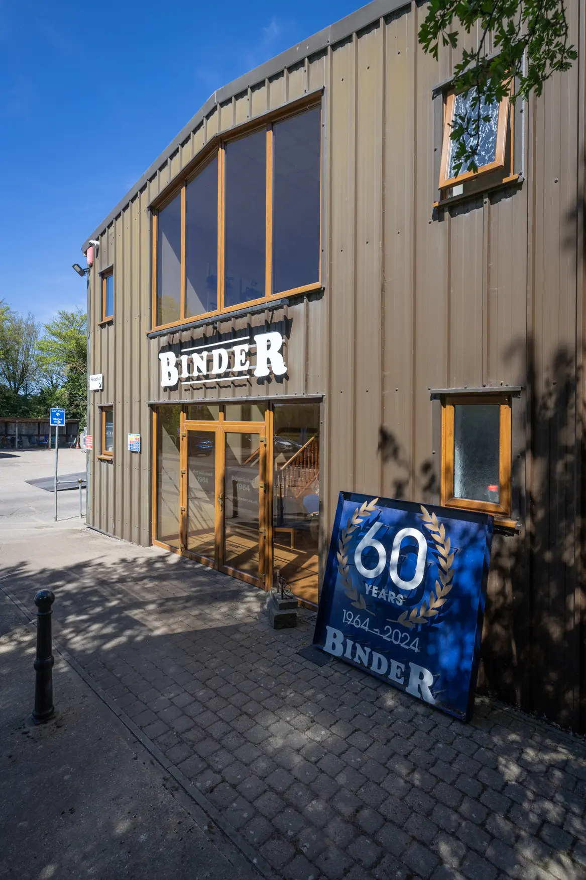 Outside the front of Binder HQ with 60th logo